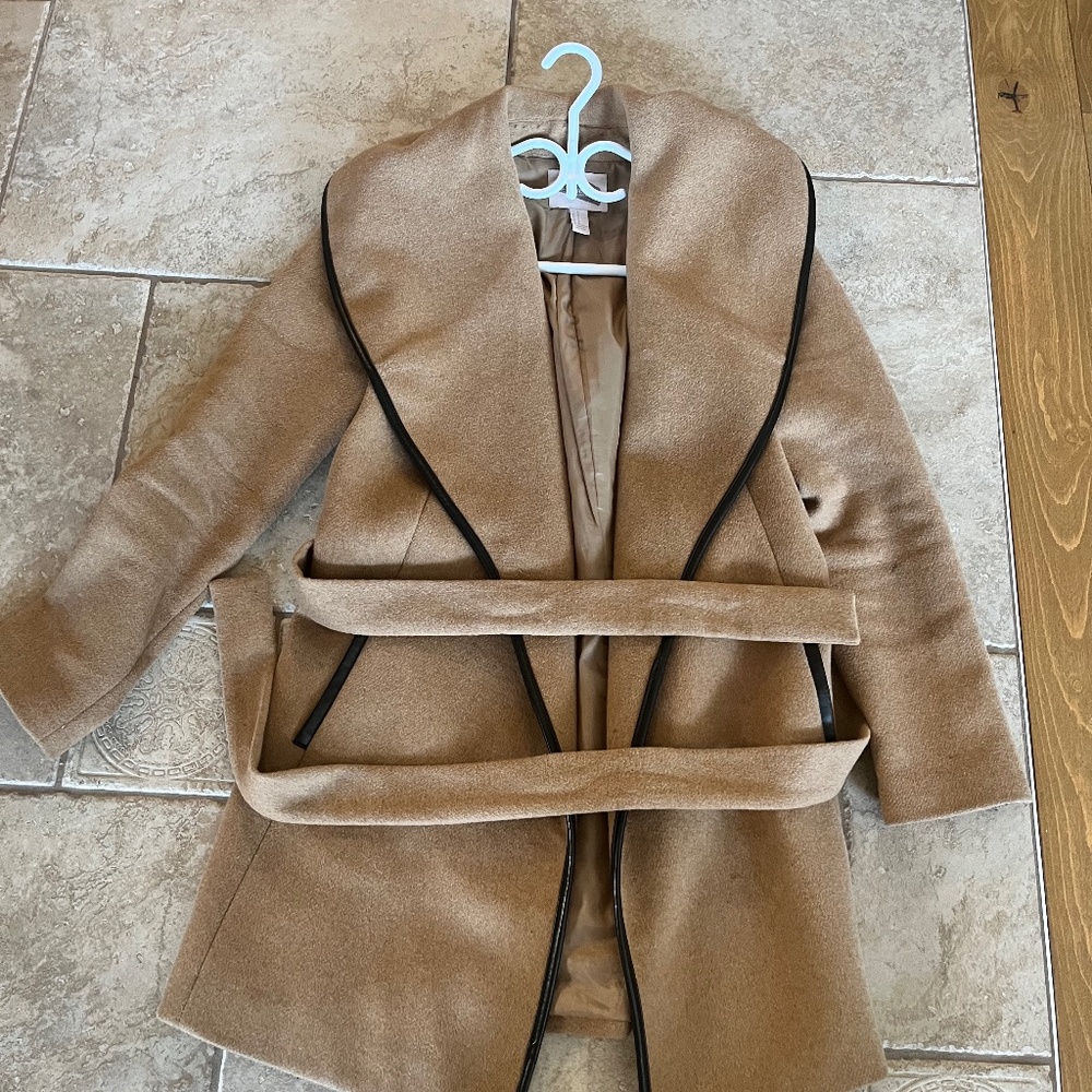 Beige knee length jacket with black trimmings